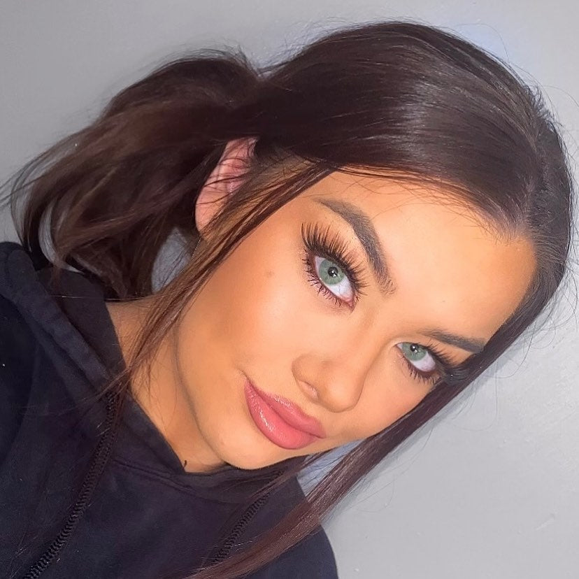 Close-up portrait of a woman with striking green eyes wearing Perfect Hue Meloni Green contact lenses, showcasing a bold and natural look.