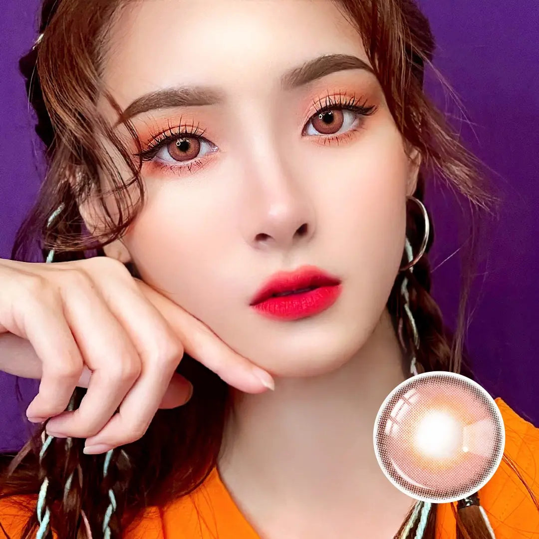 Portrait of a model wearing Say Yes Idol Red lenses, paired with vibrant red lipstick and bold eye makeup for a striking appearance.