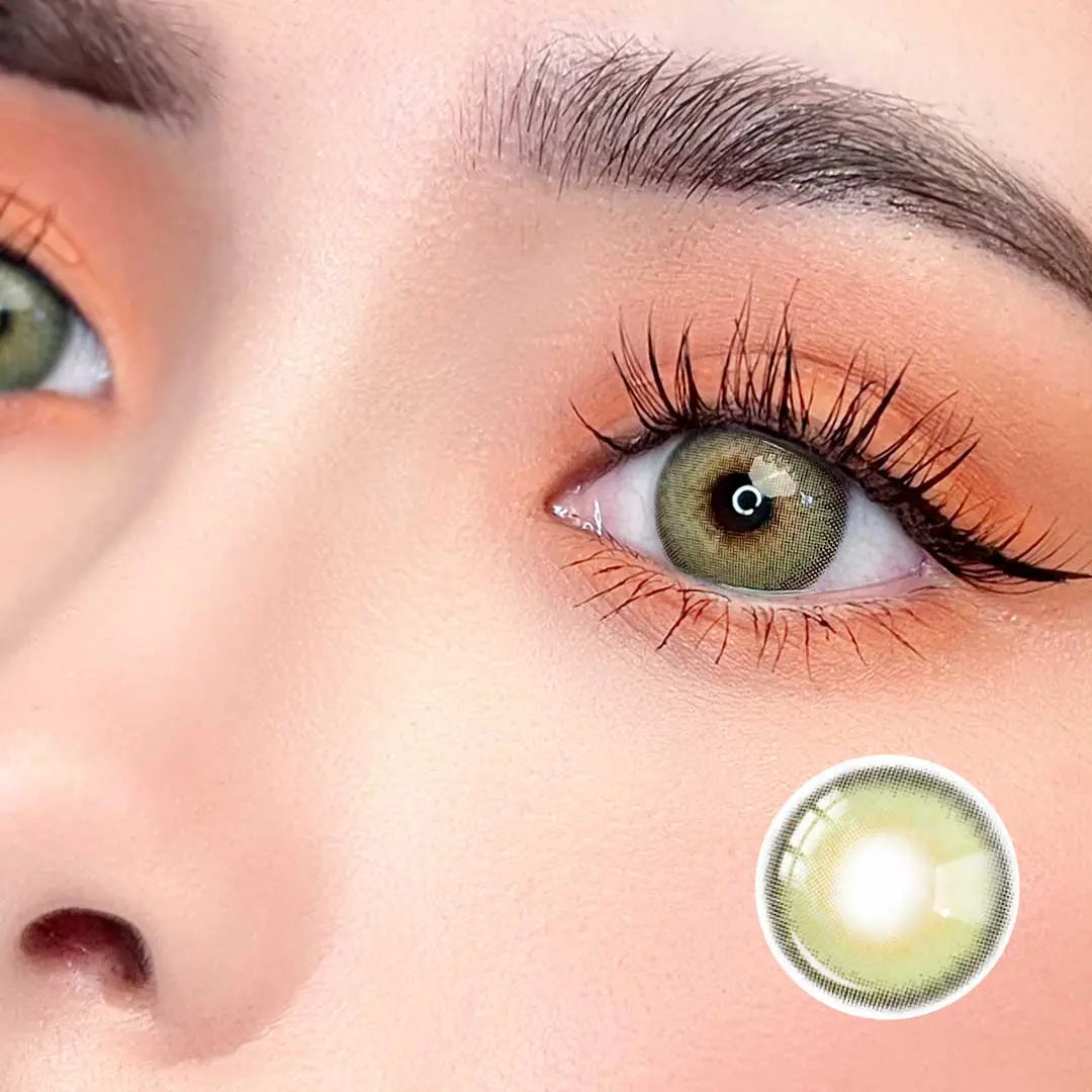 Zoomed-in view of a model wearing Say Yes Dancing Green lenses, showcasing their bright green shade with warm makeup accents.
