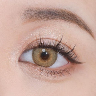 Close-up shot of an eye wearing Say Yes Crush Brown lenses, showcasing their vibrant brown tones and defining design.