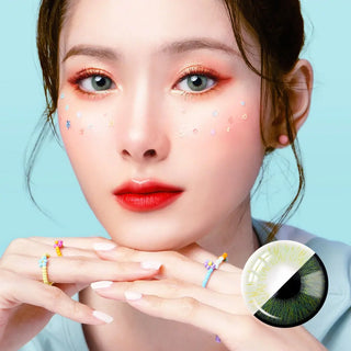 Front-facing portrait of a model wearing Perfect Hue Meloni Green lenses, accented with colorful makeup and soft pastel designs on the cheeks.